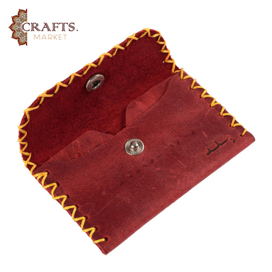 A handmade red leather snap wallet