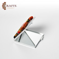 A mirror decorated with hand embroidery