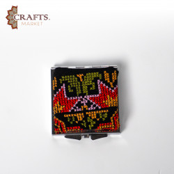 A mirror decorated with hand embroidery