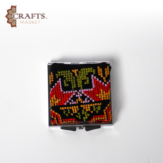 A mirror decorated with hand embroidery A mirror decorated with hand embroidery