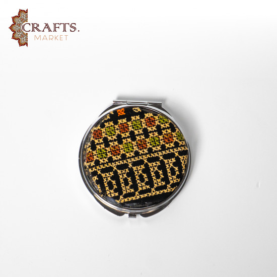 A mirror decorated with hand embroidery