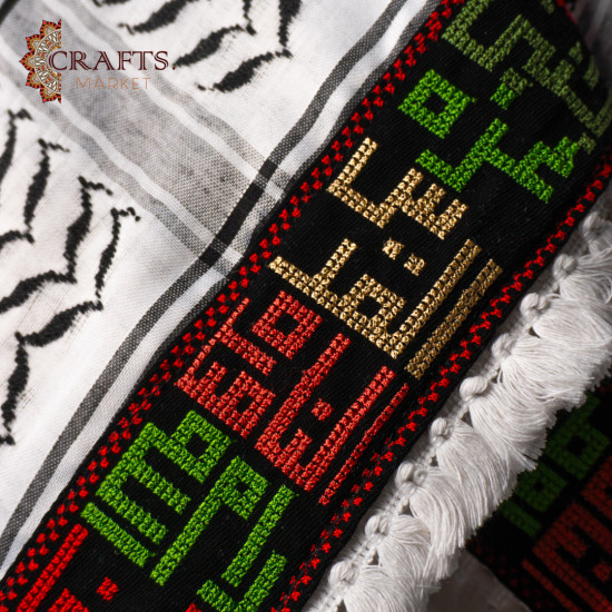 A hand-embroidered keffiyeh with the names of Palestinian cities