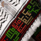 A hand-embroidered keffiyeh with the names of Palestinian cities