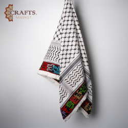 A hand-embroidered keffiyeh with the names of Palestinian cities