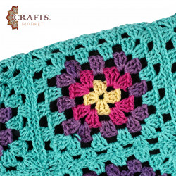 A handmade crochet clutch bag