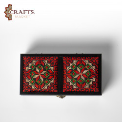 A handmade wooden gift box with a multicolored embroidered design