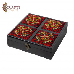 A handmade wooden gift box with a multicolored embroidered design