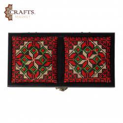 A handmade wooden gift box with a multicolored embroidered design A handmade wooden gift box with a multicolored embroidered design