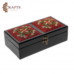 A handmade wooden gift box with a multicolored embroidered design