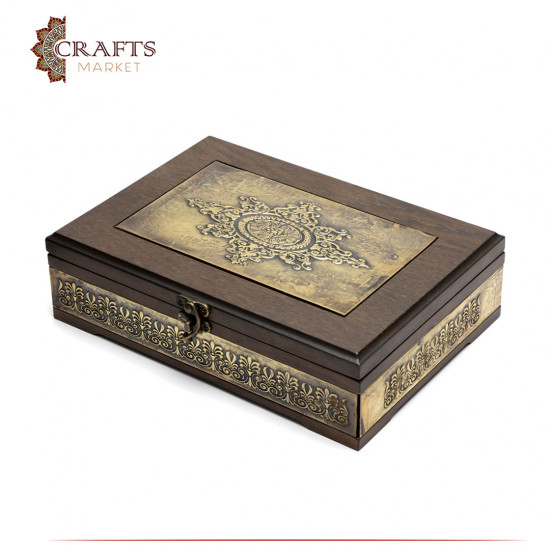 A wooden box decorated with copper and Islamic engravings