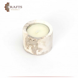Candle holder with a white candle tinged with brown