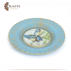 A serving plate with an image of two birds on a stump