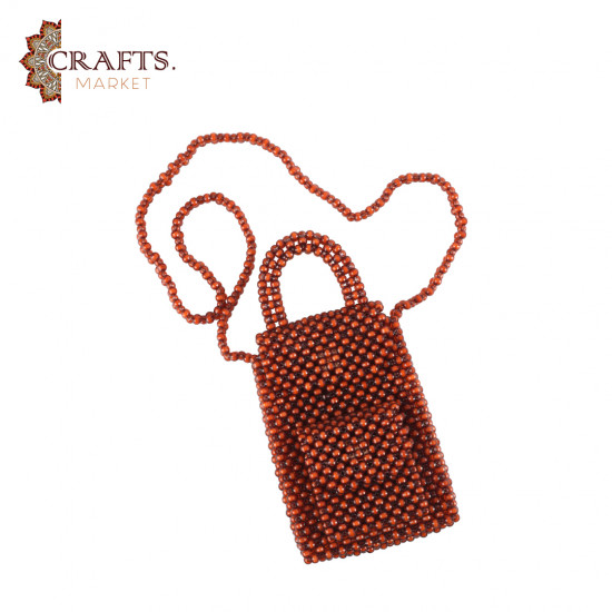 A handmade beaded bag in amber color