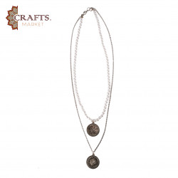 A handmade necklace made of metal, beads, and pearls